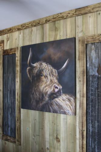 a painting of a bull with horns on a wall at The Moo-tel at Moody Meadows in Aberaeron