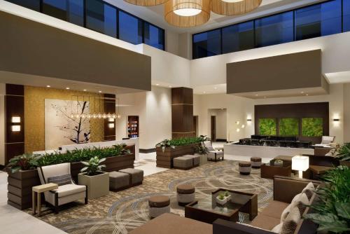 a lobby of a hotel with couches and chairs at Embassy Suites By Hilton Syracuse Destiny USA in Syracuse