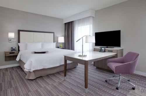 a hotel room with a bed and a desk and a tv at Hampton Inn & Suites Tyler-South in Tyler