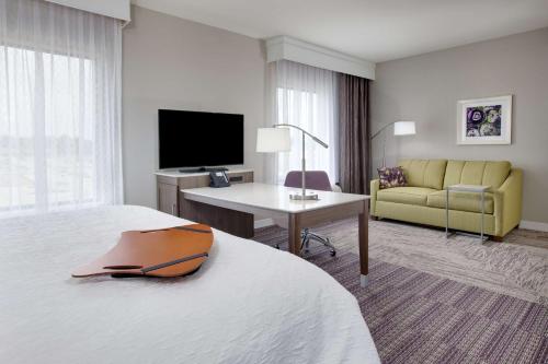 a hotel room with a bed and a desk and a television at Hampton Inn & Suites Tyler-South in Tyler