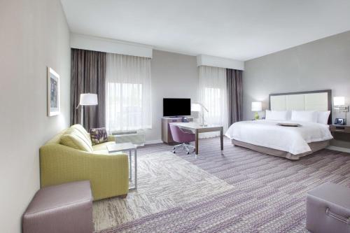 a large hotel room with a bed and a tv at Hampton Inn & Suites Tyler-South in Tyler
