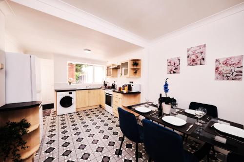 a kitchen with a table and chairs in it at Cassia, 3 Bedrooms, Sleeps 5 in Norton Canes