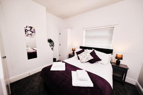 a bedroom with a large bed with two towels on it at Cassia, 3 Bedrooms, Sleeps 5 