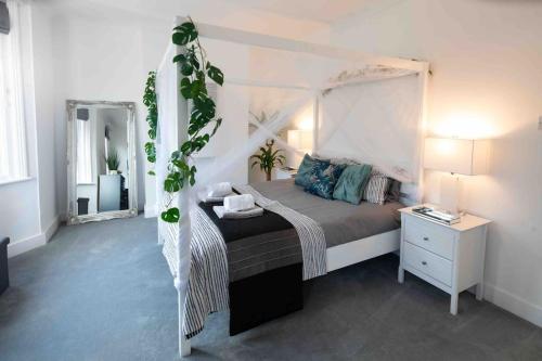 a bedroom with a bed with a white canopy at The Life Of Riley in Brighton & Hove