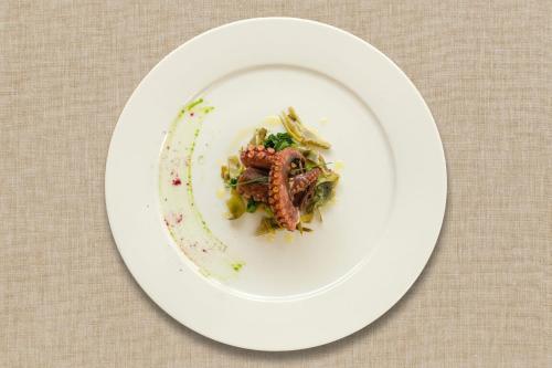 a white plate with food on a table at Agriturismo Giorgio in Mattinata