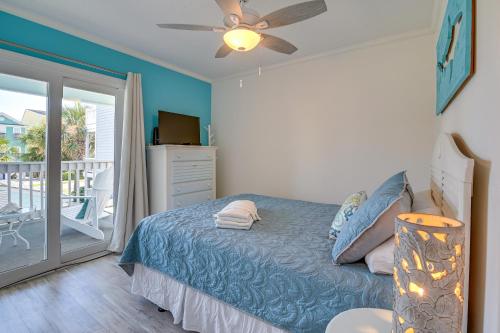 a bedroom with a bed with a ceiling fan and a balcony at Surfside Beach Escape with Pool - Walk to Ocean! in Myrtle Beach