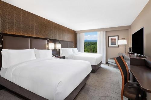 a hotel room with a large bed and a television at DoubleTree by Hilton Denver Cherry Creek, CO in Denver