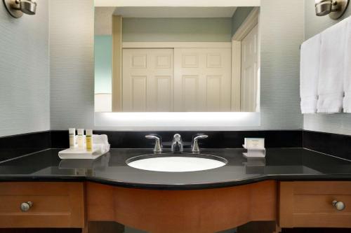 a bathroom with a sink and a mirror at Homewood Suites by Hilton Houston-Willowbrook Mall in Houston