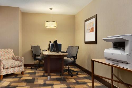 an office with a desk with a computer and chairs at Homewood Suites by Hilton Houston-Willowbrook Mall in Houston