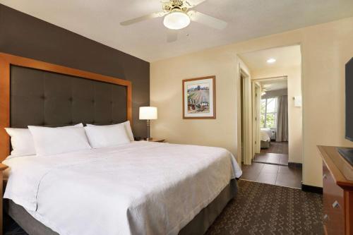 a hotel room with a large bed and a television at Homewood Suites by Hilton Allentown-Bethlehem Airport in Bethlehem