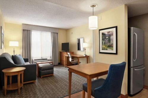 a hotel room with a dining area and a living room at Homewood Suites by Hilton Allentown-Bethlehem Airport in Bethlehem
