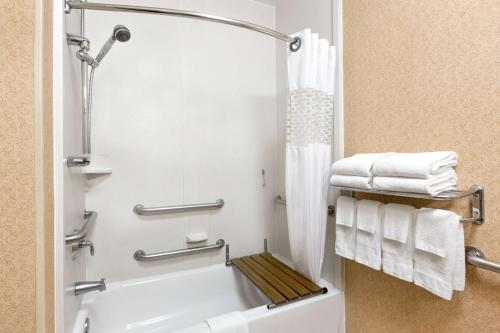 a bathroom with a bath tub and towels at Hampton Inn Houston Willowbrook Mall in Houston