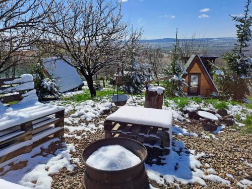a snow covered yard with two barrels of snow at Zen Garden in Oradea