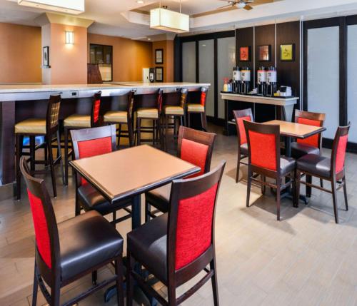 a bar in a restaurant with tables and chairs at Hampton Inn & Suites San Francisco-Burlingame-Airport South in Burlingame