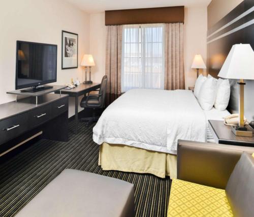 a hotel room with a bed and a flat screen tv at Hampton Inn & Suites San Francisco-Burlingame-Airport South in Burlingame