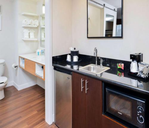 a small bathroom with a sink and a toilet at Hampton Inn & Suites San Francisco-Burlingame-Airport South in Burlingame