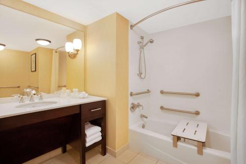 a bathroom with a sink and a tub and a shower at Homewood Suites by Hilton Tampa-Brandon in Tampa