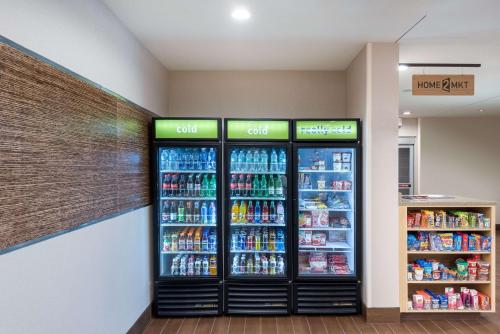a store with two refrigerators in a grocery store at Home2 Suites by Hilton Charlotte University Research Park in Charlotte