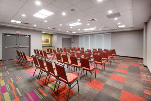 a conference room with rows of chairs and a table at Home2 Suites by Hilton Charlotte University Research Park in Charlotte