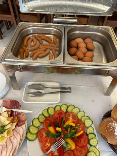a buffet of food with vegetables and meat and eggs at Hrusická restaurace a penzion in Hrusice