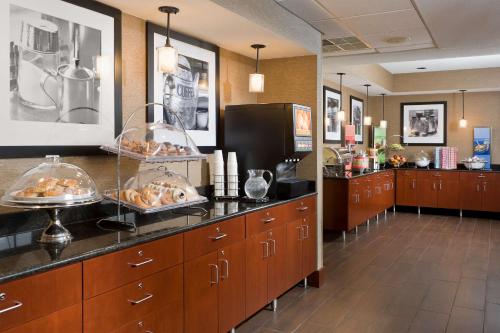 a buffet line in a restaurant with food on the counter at Hampton Inn Chicago-Tinley Park in Tinley Park
