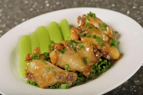 a plate of food with chicken and broccoli on a table at Hilton Garden Inn College Station in College Station
