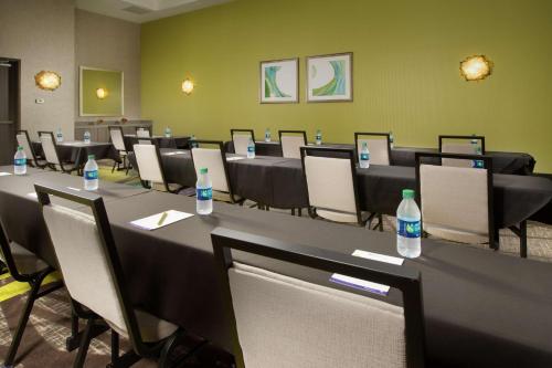a conference room with tables and chairs and bottles of water at Hilton Garden Inn College Station in College Station