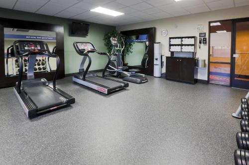 a gym with treadmills and elliptical machines at Hampton Inn & Suites by Hilton Tomball Houston NW in Tomball