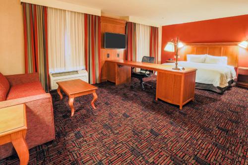a hotel room with a bed and a desk at Hampton Inn & Suites Tomball in Tomball