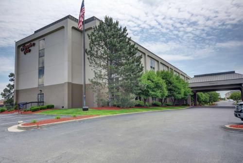 a building with an american flag in front of it at Hampton Inn by Hilton Indianapolis-South in Southport