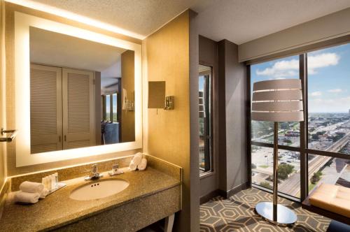 a bathroom with a sink and a large window at DoubleTree by Hilton Hotel Dallas Campbell Centre in Dallas