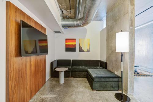 a living room with a couch and a table at NYLO Dallas Plano Hotel, Tapestry Collection by Hilton in Plano