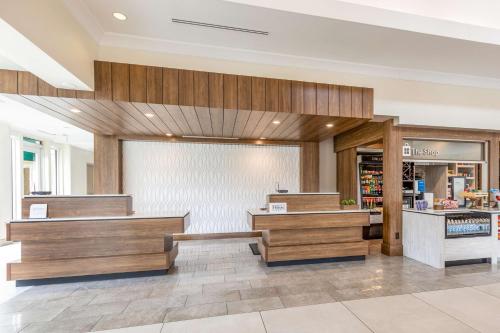 a store lobby with wooden benches in a store at Hilton Garden Inn Gilroy in Gilroy