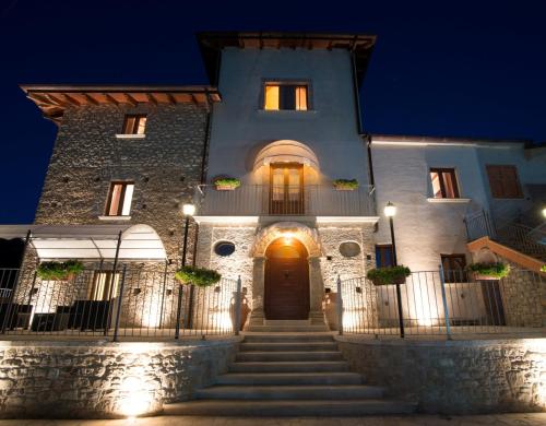a building with stairs leading to a door at night at Agriturismo U' Casinu dà Scala in Campora San Giovanni