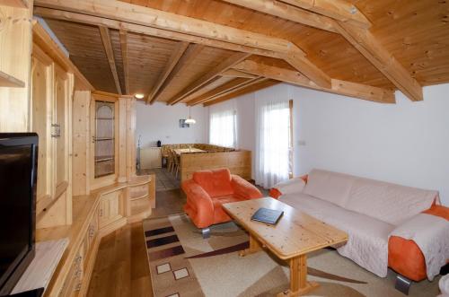 a living room with a couch and a table at Familienhotel Steindl in Millstatt