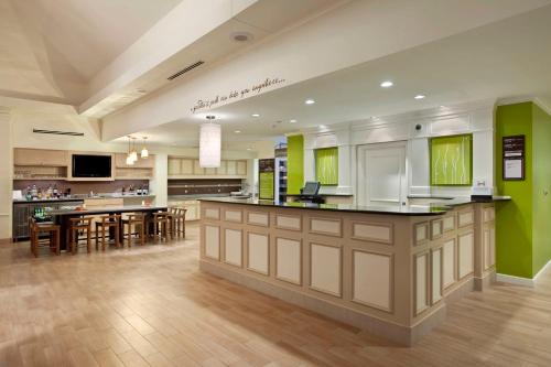 a large kitchen with green walls and wooden floors at Hilton Garden Inn Cleveland/Twinsburg in Twinsburg