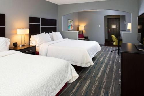 a hotel room with two beds and a desk at Hampton Inn Glenwood Springs in Glenwood Springs
