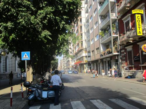 a person riding a scooter on a city street at Hotel Costa in Bari