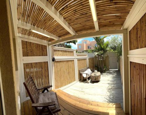 an outdoor patio with a wooden pergola at Pearl of the sea in H̱adera