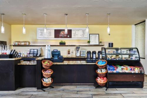 a restaurant with a counter with a food counter at DoubleTree by Hilton Hotel Salt Lake City Airport in Salt Lake City