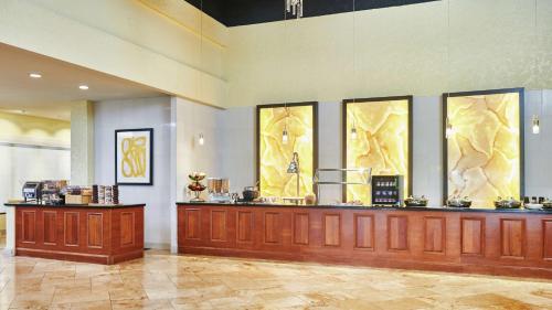 a restaurant with a counter in a lobby at DoubleTree by Hilton Hotel Salt Lake City Airport in Salt Lake City