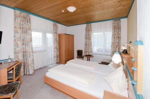a bedroom with a bed and a desk at Familienhotel Steindl in Millstatt