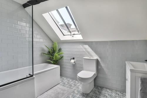 a bathroom with a toilet and a sink and a skylight at Paradise Square - Remodelled 18th Century Apartme in Sheffield