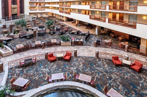 an overhead view of therium of a hotel with a pool and red chairs at Embassy Suites by Hilton Albuquerque in Albuquerque