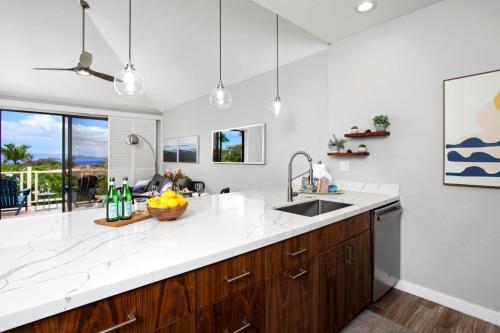 a kitchen with white countertops and a sink at KBM Resorts Grand Champions GCH 42 NEW Remodeled 2 Bedrooms Villa in Heart of Wailea Includes Rental Car in Wailea