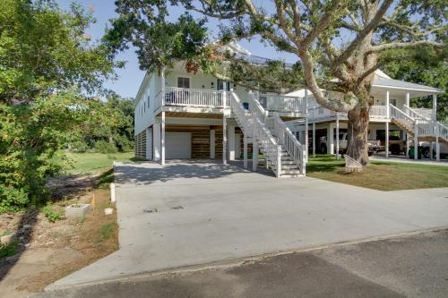 a large white house with a tree at Sunny Gulfport Vacation Rental Walk to Beaches! in Gulfport