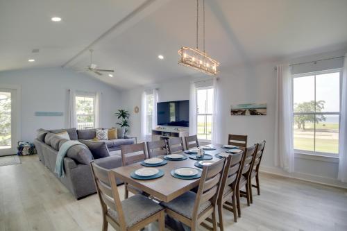a dining room and living room with a table and chairs at Sunny Gulfport Vacation Rental Walk to Beaches! in Gulfport
