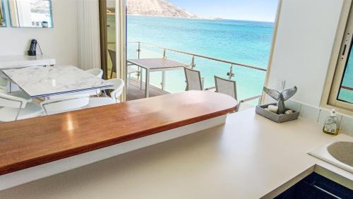 a room with a table and a view of the ocean at Residence Catalina APT 3 in Grand Case