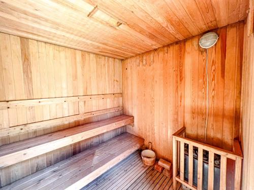 a wooden sauna with a bench in a room at Villa Logu in Theth