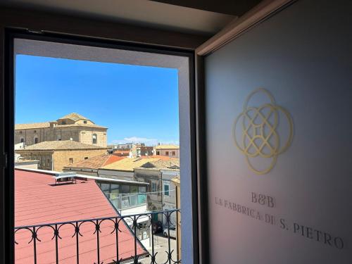 a window with a view of a building at La Fabbrica di San Pietro Vasto in Vasto
